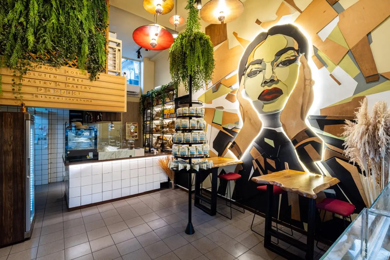 Inside the Marinos Kosmas bakery with its painted mural and pastry counter