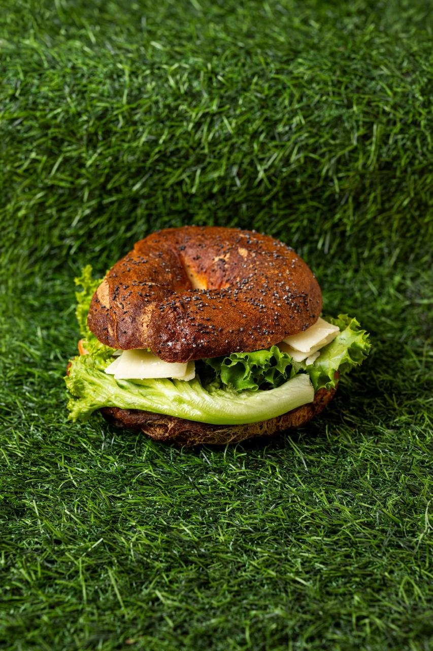 Dark gluten-free bagel burger with lettuce